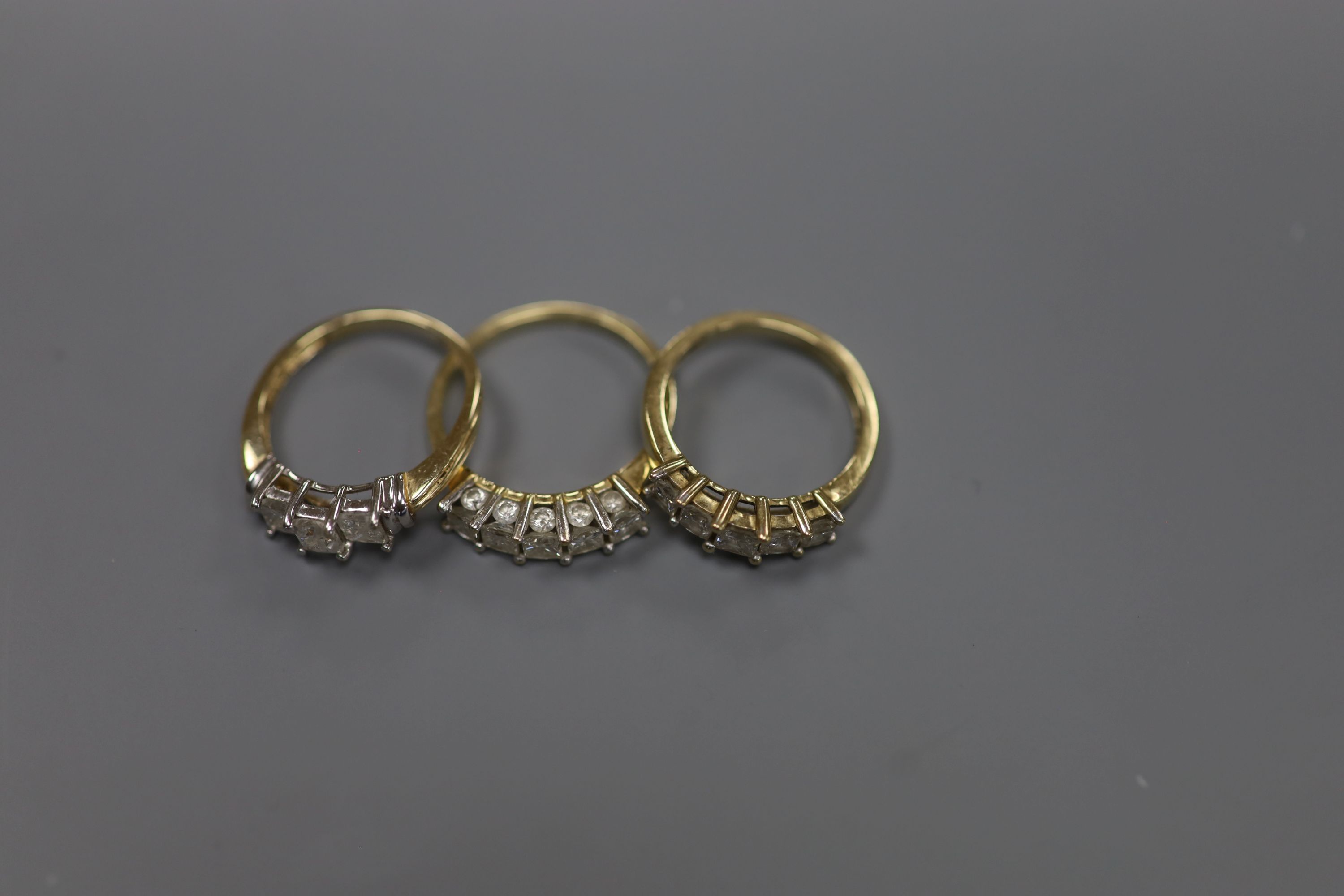 Two modern 9ct gold and five stone diamond set half hoop rings, sizes N & R/S gross 6.4 grams and a similar 14ct gold and three stone diamond ring, size P, gross 2.7 grams.